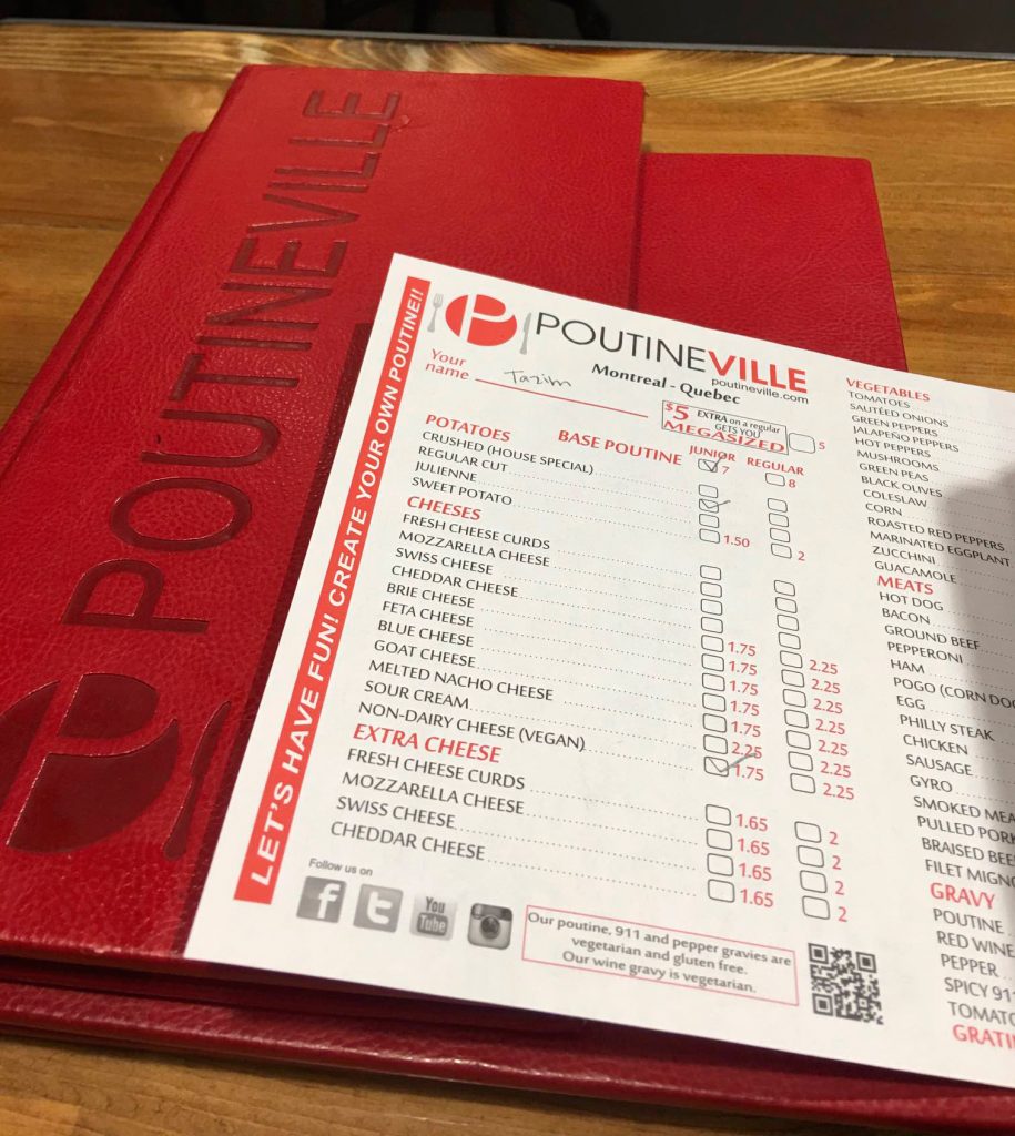 A close-up of a personalized order form from Poutineville, where Tazim wrote her name and selected vegan poutine options. This restaurant lets you customize everything&mdash;including plant-based toppings&mdash;making it a great solo-friendly and vegan-aware spot in Quebec City.