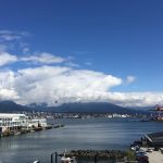 Canada Place view and Burrard Inlet Vancouver, Canada. North Shore Mountains in the background. The Canada Place Terminal is where most cruise ships depart and arrive for cruise ships to Alasks, Hawaii, and elsewhere.
