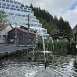 Water from a small fountain rises in front of the iconic terraced Mill No. 3 building at Britannia Mine Museum. The juxtaposition of quiet ripples and looming industrial history perfectly sums up the museum&rsquo;s layered experience.