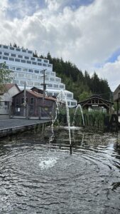 Water from a small fountain rises in front of the iconic terraced Mill No. 3 building at Britannia Mine Museum. The juxtaposition of quiet ripples and looming industrial history perfectly sums up the museum&rsquo;s layered experience.