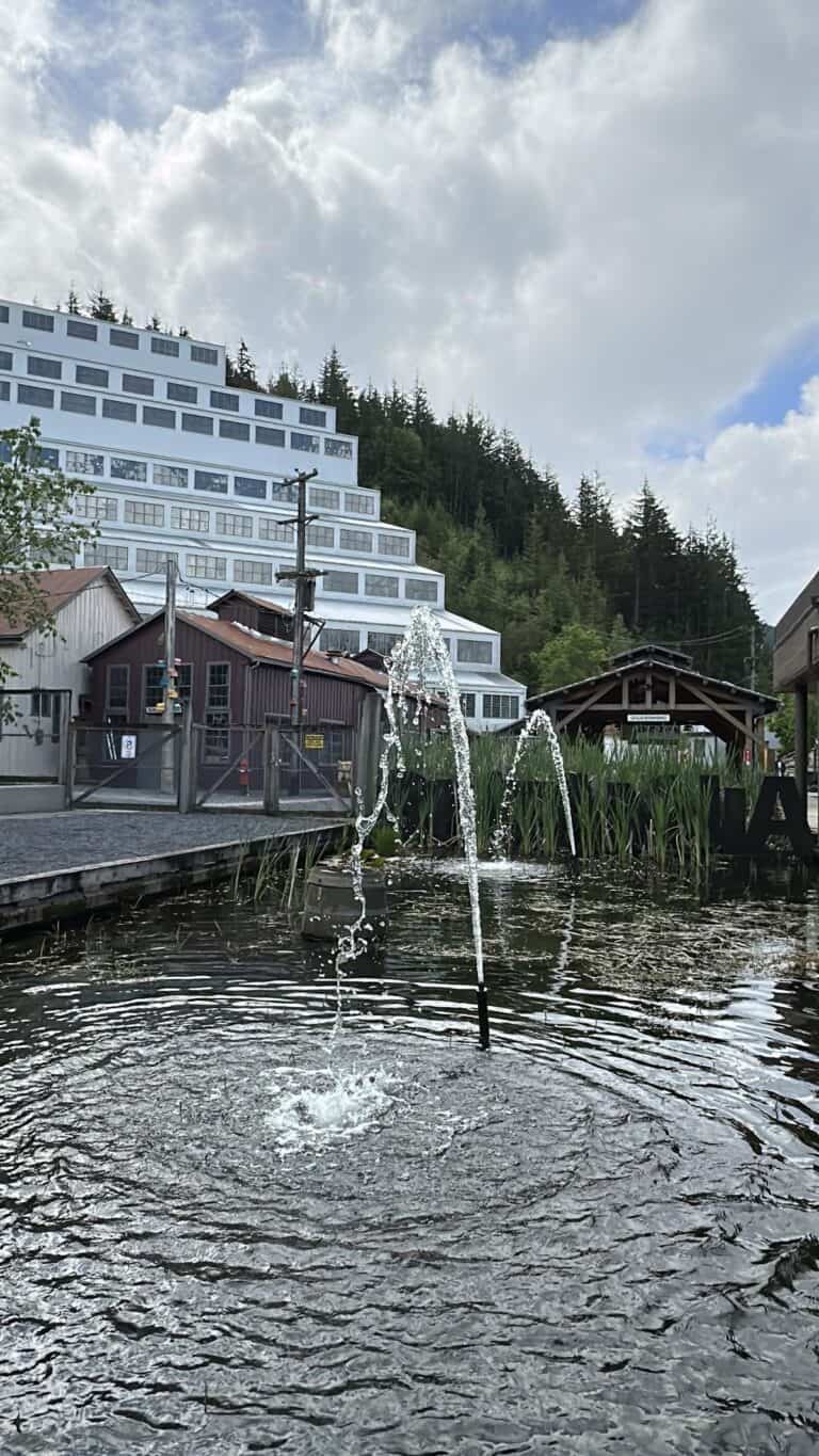 Water from a small fountain rises in front of the iconic terraced Mill No. 3 building at Britannia Mine Museum. The juxtaposition of quiet ripples and looming industrial history perfectly sums up the museum&rsquo;s layered experience.