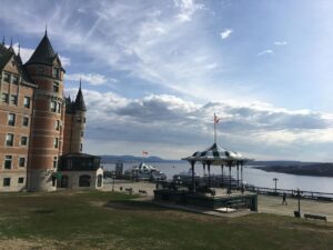 Waterfront view from Ch&acirc;teau Frontenac in Qu&eacute;bec City, with the hotel's turrets on the left and a striped gazebo overlooking the St. Lawrence River.