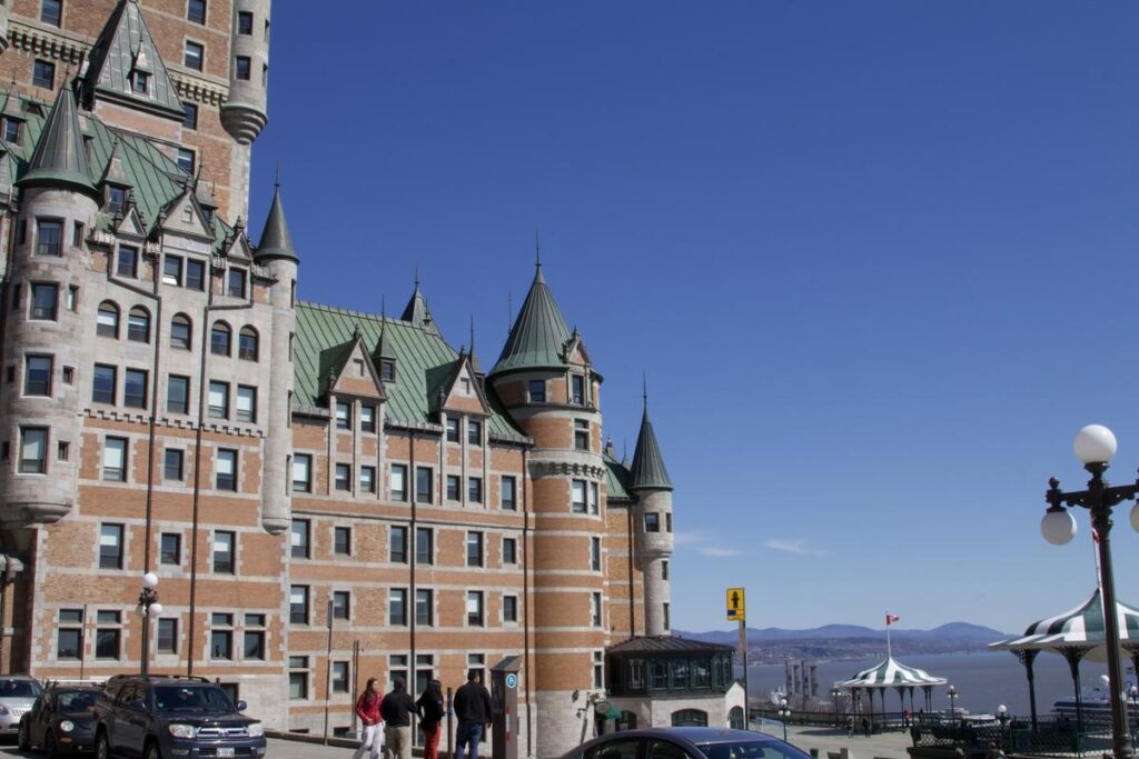 The Ch&acirc;teau Frontenac rises above Old Quebec with its signature green turrets and castle-like structure under a clear blue sky. This world-famous hotel is one of Quebec City&rsquo;s most recognizable landmarks and a symbol of its historic charm.