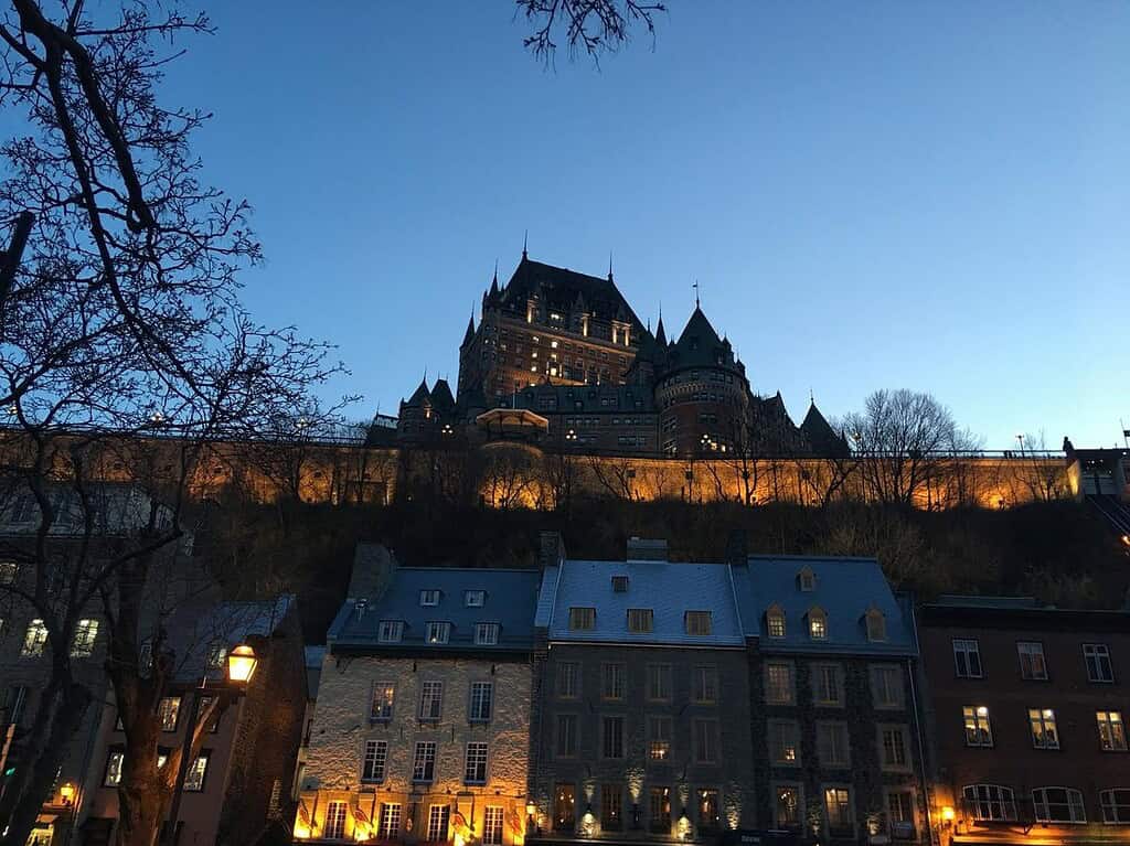 The Château Frontenac lit up at dusk, rising above the stone buildings of Old Quebec as the sky transitions into night. It’s the perfect framing spot for nighttime shots with lots of texture and historic charm.