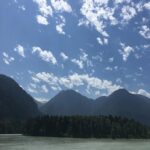 A view of the Fraser River with tree-covered mountains rising in the background under a sky scattered with white clouds. The scenery from Fort Hope makes this historic site a peaceful and photogenic addition to any 3 days in the Fraser Valley.