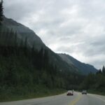 A forested mountain highway winding through the Shuswap region near Salmon Arm, British Columbia&mdash;highlighting Salmon Arm activities like scenic drives, road trips, and nearby adventures in the area.