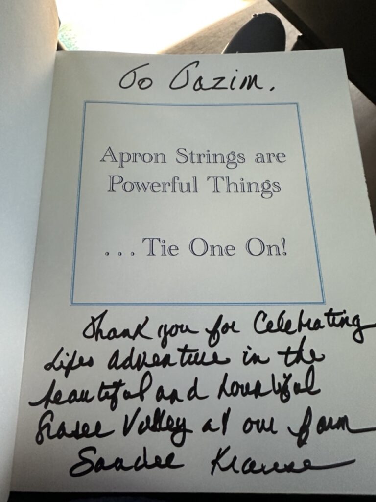 Open book showing a handwritten personal inscription on the interior page, a gift from Sandee Krause at Krause Berry Farms in Langley BC