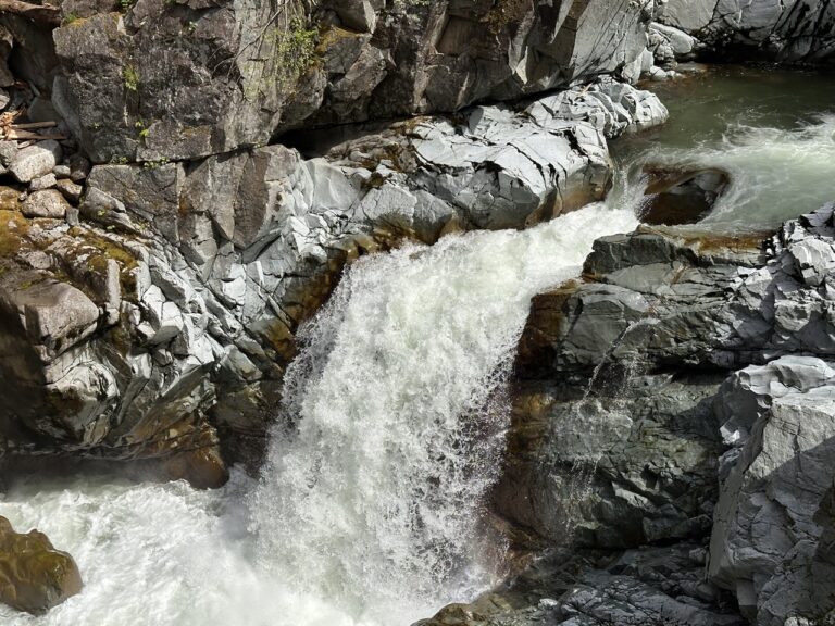 Close-up of water rushing over grey rock at Mamquam Falls, Squamish Canyon, Squamish BC, Canada. Photo by Tazim Damji.
